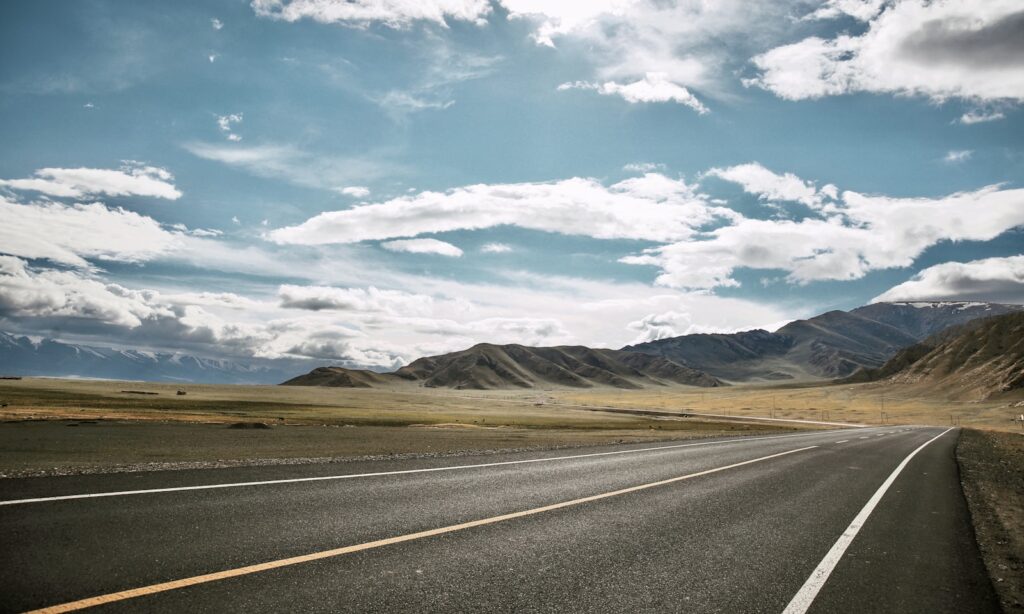 Concrete highway stretching into the distance under daylight