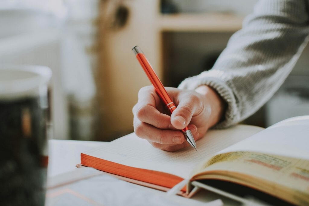 Notebook and red pen on a desk for permit test study