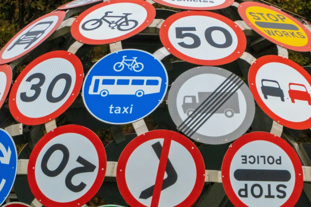 Road signs cluster on a post - what to expect on the test