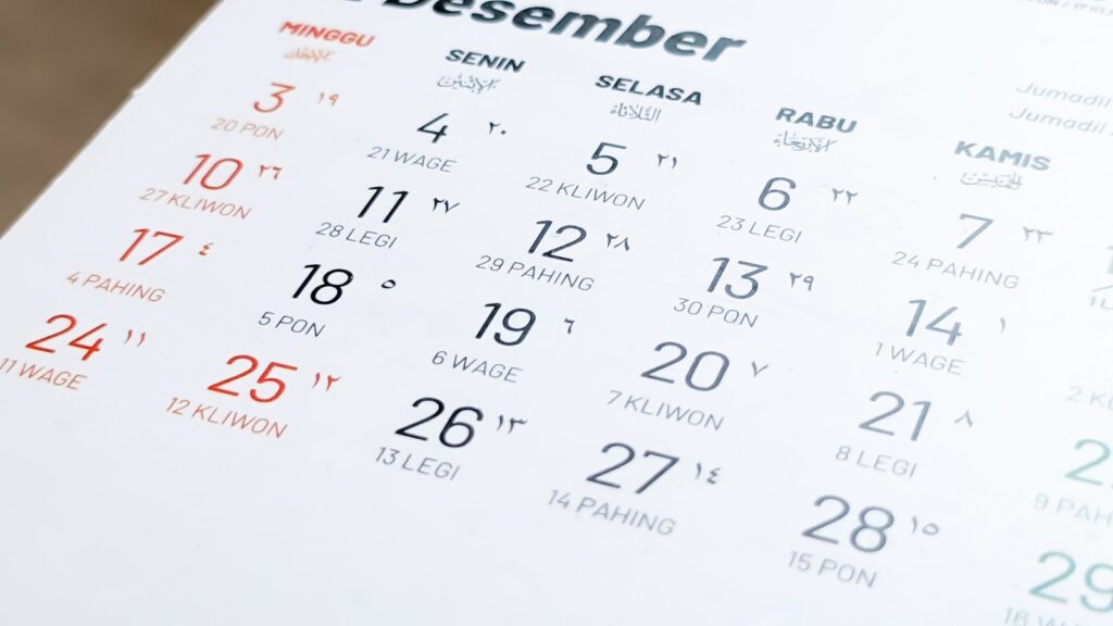 A close-up of a paper wall calendar on a table