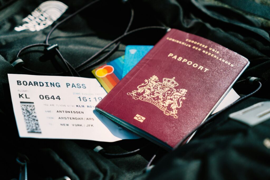 A US passport and a boarding pass resting on a travel bag