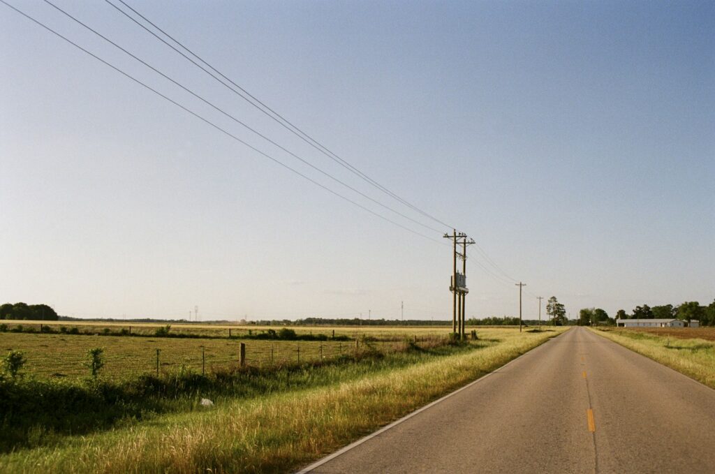 Empty two-lane road stretching through rural Alabama countryside