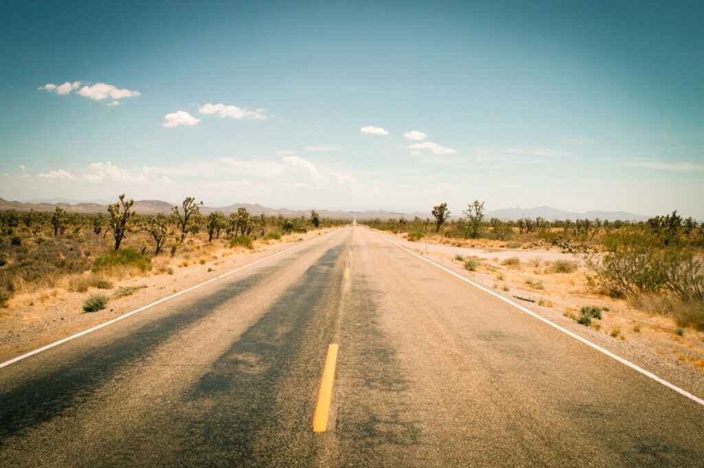 Empty desert highway through the Arizona Joshua tree landscape