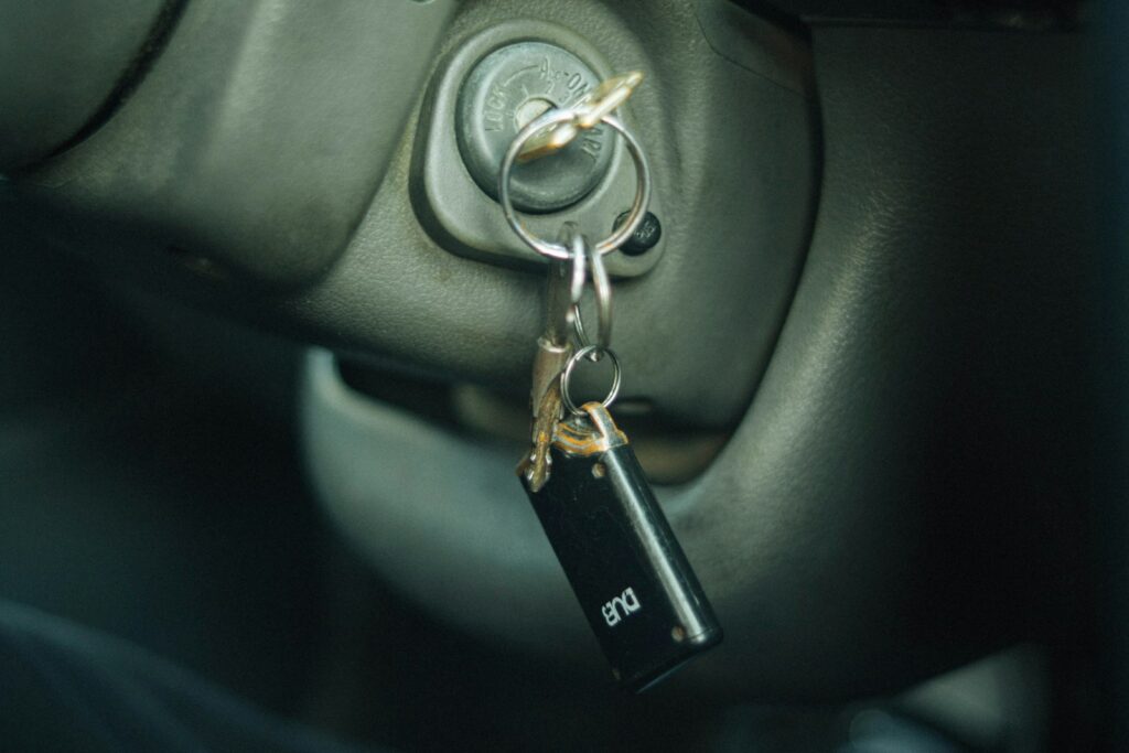 Car key chain hanging from a car door handle