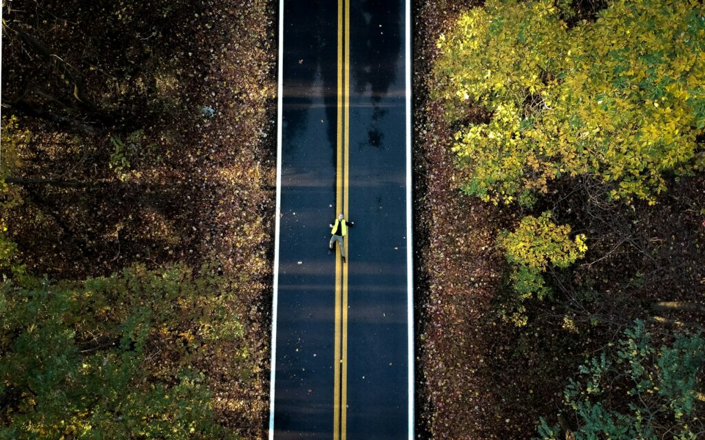 Aerial view of a two lane road curving through green Virginia countryside