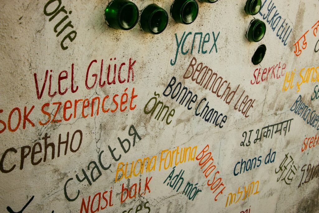 Wall covered with handwritten good luck messages in many different languages