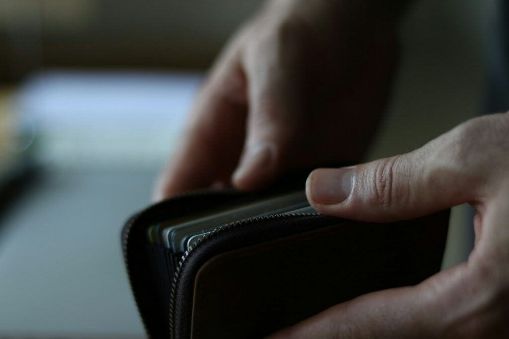 A person holding an open wallet in one hand