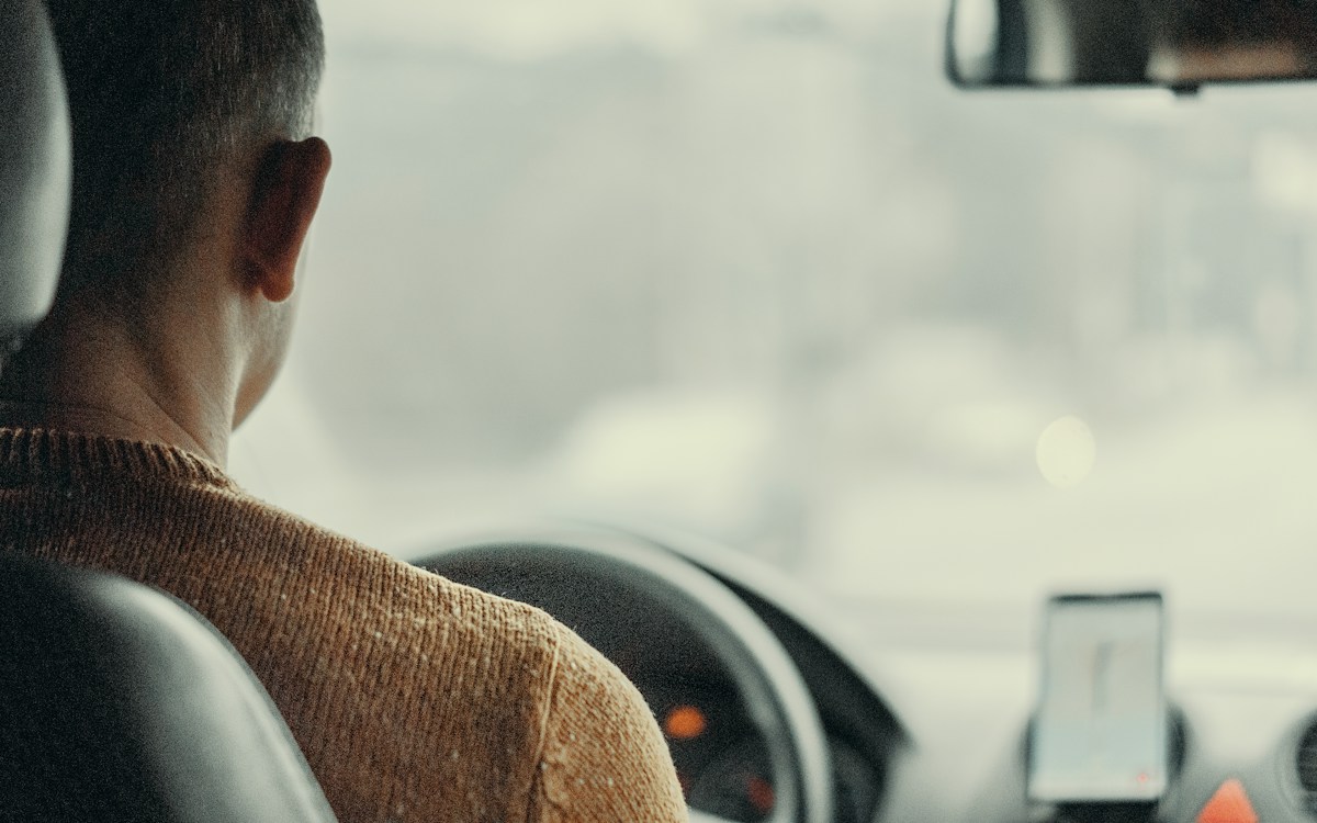 A driver at the wheel seen from the back seat, representing the supervised practice hours that stay on record even after a learner permit expires